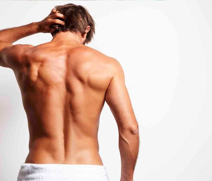 Hombre posando de espaldas con su torso desnudo - Homme Luxury Barbers
